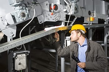 Technician repairing conveyor